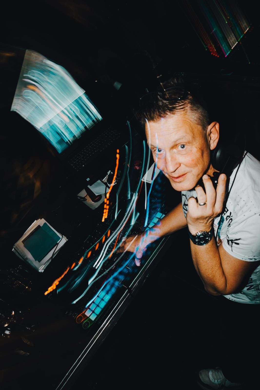 DJ Paul am Pult, umgeben von Lichtspuren